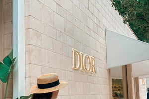 A female walking past a DIOR storefront