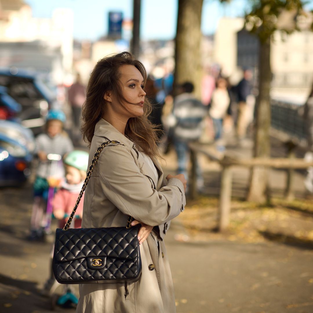 female in the park with her black chanel second handbag